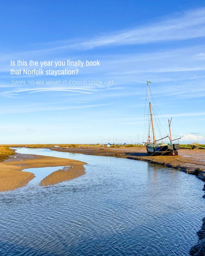 A coastal creek with a boat docked in the sand.