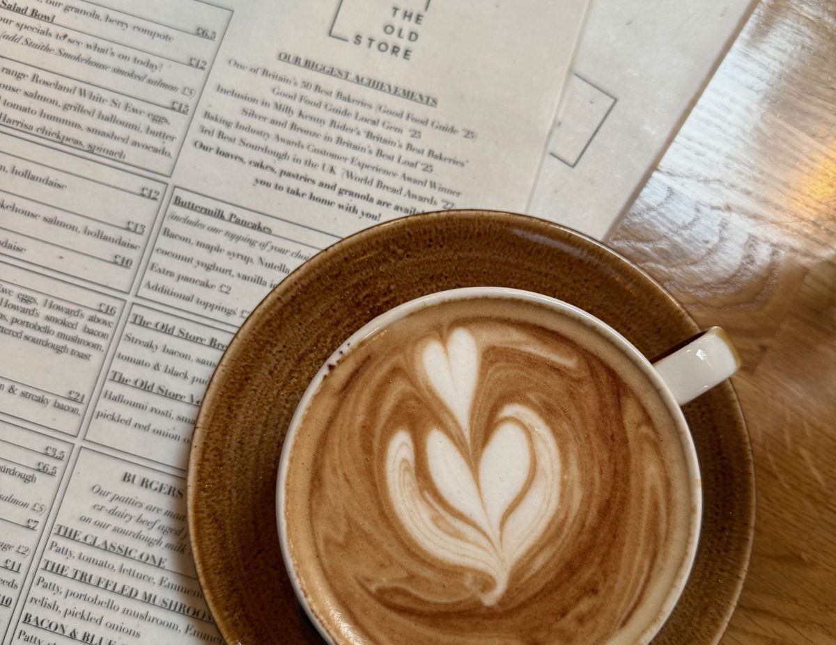 A freshly brewed coffee on top of two menus